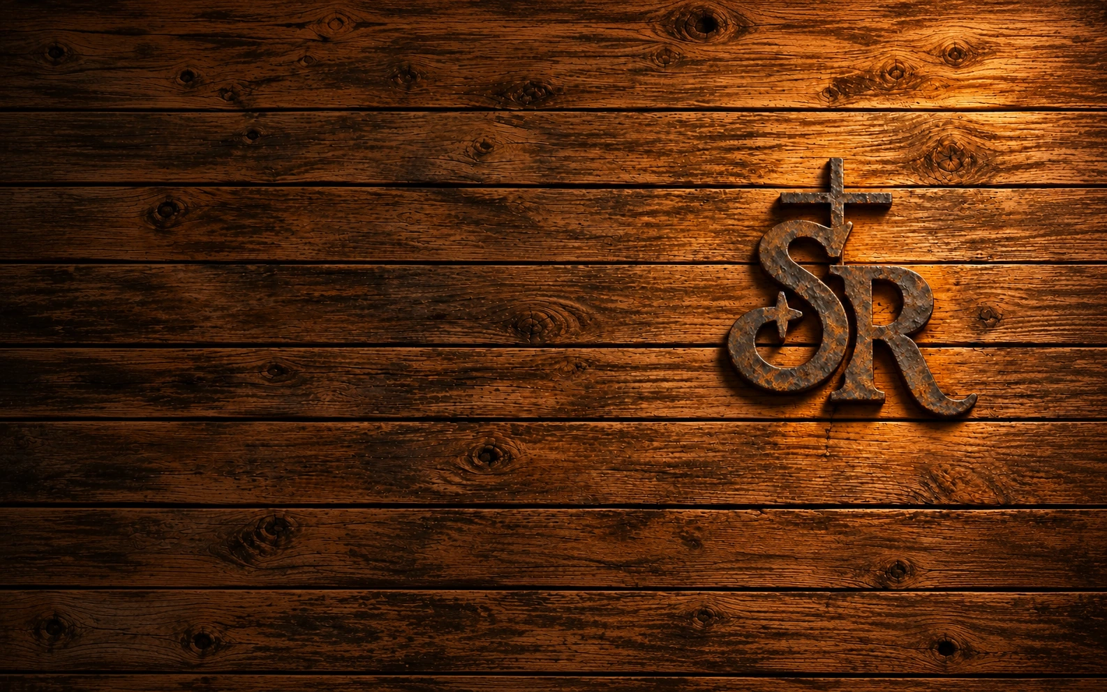 Forged Starfish Ranch SR brand with an integrated cross and star on dark weathered barn wood